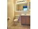 Bathroom featuring a vanity with a decorative mirror and a white toilet at 8837 Latrec Ave # 5307, Orlando, FL 32819