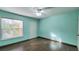 Clean bedroom featuring light-colored walls, a ceiling fan, a window, and hardwood floors at 8837 Latrec Ave # 5307, Orlando, FL 32819