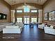 Bright clubhouse with high ceilings, modern white couches, flatscreen TV and large windows looking out to the pool area at 8837 Latrec Ave # 5307, Orlando, FL 32819