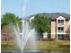 Exterior shot of community buildings with a decorative fountain in the foreground at 8837 Latrec Ave # 5307, Orlando, FL 32819
