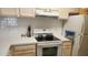 Close-up of a well-lit kitchen featuring white cabinets, quartz countertops, and stainless steel appliances at 8837 Latrec Ave # 5307, Orlando, FL 32819