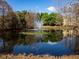 Scenic view of a pond with a fountain in a tranquil community setting at 8837 Latrec Ave # 5307, Orlando, FL 32819