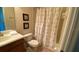 Bathroom with shower tub and decorative floral curtain at 8991 Cuban Palm Rd, Kissimmee, FL 34747