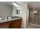 Bathroom featuring granite countertop vanity and glass shower at 8991 Cuban Palm Rd, Kissimmee, FL 34747