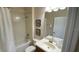 Standard bathroom featuring a shower with a tub, toilet, and a vanity with a sink and mirror at 8991 Cuban Palm Rd, Kissimmee, FL 34747