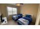 Bedroom with two twin beds, neutral walls and a window with curtain at 8991 Cuban Palm Rd, Kissimmee, FL 34747