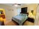 Bedroom featuring a queen bed, two nightstands with lamps, and artwork on the wall at 8991 Cuban Palm Rd, Kissimmee, FL 34747
