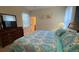 Comfortable bedroom with a king bed, dresser, lamp, and a view into another room at 8991 Cuban Palm Rd, Kissimmee, FL 34747