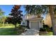 Charming home featuring a two-car garage, lush green lawn and garden, with tidy landscaping at 8991 Cuban Palm Rd, Kissimmee, FL 34747