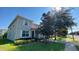 Two-story home featuring a well-maintained lawn and landscaping with inviting shuttered windows and a red tile roof at 8991 Cuban Palm Rd, Kissimmee, FL 34747