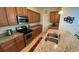 Kitchen featuring granite countertops, stainless appliances and wood cabinets at 8991 Cuban Palm Rd, Kissimmee, FL 34747