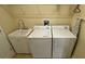 Functional laundry room with a sink, washing machine, dryer, and ironing board for convenience at 8991 Cuban Palm Rd, Kissimmee, FL 34747