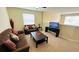 Cozy living room with comfortable sofas, a coffee table, and a TV for relaxation and entertainment at 8991 Cuban Palm Rd, Kissimmee, FL 34747