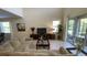 Inviting living room with high ceilings, large windows, neutral decor, and sliding doors to an outdoor patio at 8991 Cuban Palm Rd, Kissimmee, FL 34747
