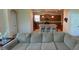 Open-concept living space seamlessly integrates a kitchen, an island with barstool seating, and a cozy living room at 8991 Cuban Palm Rd, Kissimmee, FL 34747