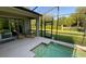 Home patio features a splash pool, glass sliding doors, an outdoor table with chairs and a view of green space at 8991 Cuban Palm Rd, Kissimmee, FL 34747