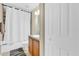 Bright bathroom features a shower-tub combination with a white shower curtain and vanity at 96 Pecan Dr, Ocala, FL 34472