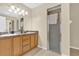Bright bathroom featuring a double sink vanity and a tiled shower with a glass door at 96 Pecan Dr, Ocala, FL 34472