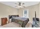 Bedroom with a ceiling fan and view to the exterior at 96 Pecan Dr, Ocala, FL 34472