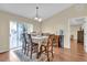 Bright dining area featuring a large window, hardwood floors, and a stylish chandelier at 96 Pecan Dr, Ocala, FL 34472