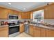 Functional kitchen with stainless steel appliances, ample counter space, and a bright window at 96 Pecan Dr, Ocala, FL 34472