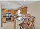Well-lit kitchen featuring tile floors, modern appliances, and a cozy breakfast bar at 96 Pecan Dr, Ocala, FL 34472