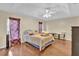 Bright main bedroom featuring hardwood floors and a ceiling fan at 96 Pecan Dr, Ocala, FL 34472