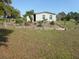 Backyard featuring decorative wooden perimeter outlining beautiful flower beds and comfortable seating at 361 Wade Park Ct, Davenport, FL 33897