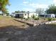 Spacious backyard with meticulous landscaping and well-defined garden beds framed by charming wooden borders at 361 Wade Park Ct, Davenport, FL 33897