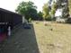 Expansive backyard with a screened porch, garden beds, and ample space for outdoor activities at 361 Wade Park Ct, Davenport, FL 33897