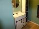Modern bathroom with a vanity featuring dark hardware and a round mirror, offering contemporary style at 361 Wade Park Ct, Davenport, FL 33897