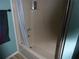 Clean bathroom showcasing a shower with blue accents, complemented by a towel rack for added convenience at 361 Wade Park Ct, Davenport, FL 33897