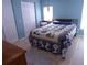 Cozy bedroom with wood-look floors, bright blue walls, and ample closet space at 361 Wade Park Ct, Davenport, FL 33897