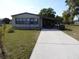 Charming single-story home with a long driveway and lush green lawn at 361 Wade Park Ct, Davenport, FL 33897