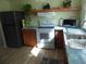 Updated kitchen featuring stainless steel appliances and wooden cabinets, offering a functional and stylish space at 361 Wade Park Ct, Davenport, FL 33897
