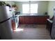 Well-lit kitchen with wooden cabinets, modern appliances, and a large window over the sink at 361 Wade Park Ct, Davenport, FL 33897