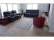 Comfortable living room features modern furniture, light wood floors, and plenty of natural light at 361 Wade Park Ct, Davenport, FL 33897