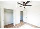 Bedroom featuring wood-look floors, a ceiling fan, and a closet at 1203 Baranova Rd, Ocoee, FL 34761