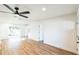 The open living room has wood-look flooring and a ceiling fan at 1203 Baranova Rd, Ocoee, FL 34761