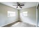 Bedroom with speckled carpeting, natural lighting, and a ceiling fan at 1205 Flewelling Ave, Ocoee, FL 34761