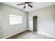 A comfortably sized bedroom with window, ceiling fan and closet at 1205 Flewelling Ave, Ocoee, FL 34761