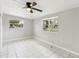 Bright bedroom featuring tile flooring, ceiling fan, and dual windows at 1205 Flewelling Ave, Ocoee, FL 34761