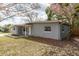 A lovely single-story home featuring a well-maintained grey brick exterior and a covered entrance at 1205 Flewelling Ave, Ocoee, FL 34761