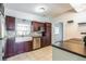 Modern kitchen showcasing stainless steel appliances, dark cabinets, tile backsplash, and a farmhouse sink at 1205 Flewelling Ave, Ocoee, FL 34761