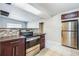 Well-equipped kitchen featuring stainless steel appliances, dark wooden cabinets, and sleek countertops at 1205 Flewelling Ave, Ocoee, FL 34761