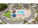 Community pool and playground area, showcasing a large pool, play equipment, and surrounding residential streets at 1212 Bear Oak Ln, Deland, FL 32720