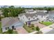 Aerial view of a two-story home with a three-car garage, brick driveway, and landscaped front yard at 1212 Bear Oak Ln, Deland, FL 32720