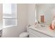 Clean, well-lit half bathroom with quartz countertop, modern fixtures, and a window at 1212 Bear Oak Ln, Deland, FL 32720