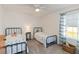 Bright bedroom with matching beds and a large window at 1212 Bear Oak Ln, Deland, FL 32720