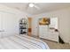Well-lit bedroom with ceiling fan, dresser, and television at 1212 Bear Oak Ln, Deland, FL 32720